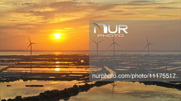 A wind farm is being seen at sunset in Wuxi, China, on April 24, 2024. 