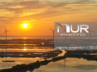 A wind farm is being seen at sunset in Wuxi, China, on April 24, 2024. (