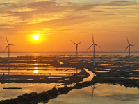 A wind farm is being seen at sunset in Wuxi, China, on April 24, 2024. (