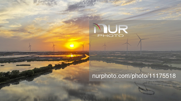 A wind farm is being seen at sunset in Wuxi, China, on April 24, 2024. 