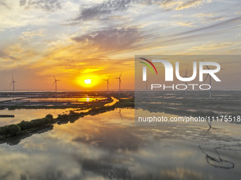 A wind farm is being seen at sunset in Wuxi, China, on April 24, 2024. (