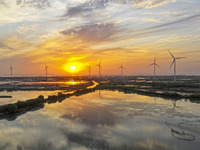 A wind farm is being seen at sunset in Wuxi, China, on April 24, 2024. (