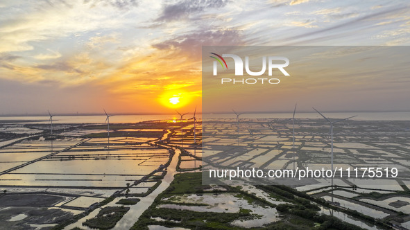 A wind farm is being seen at sunset in Wuxi, China, on April 24, 2024. 