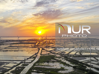 A wind farm is being seen at sunset in Wuxi, China, on April 24, 2024. (