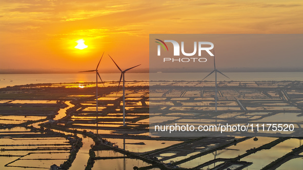 A wind farm is being seen at sunset in Wuxi, China, on April 24, 2024. 