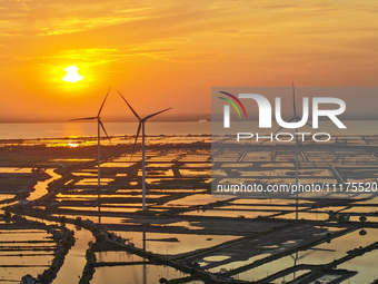 A wind farm is being seen at sunset in Wuxi, China, on April 24, 2024. (