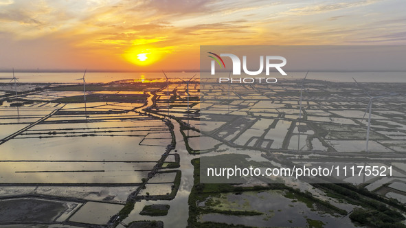 A wind farm is being seen at sunset in Wuxi, China, on April 24, 2024. 