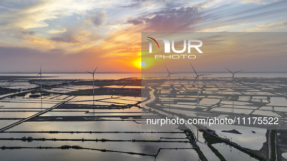 A wind farm is being seen at sunset in Wuxi, China, on April 24, 2024. 