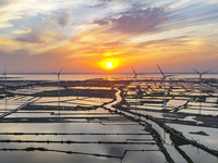 A wind farm is being seen at sunset in Wuxi, China, on April 24, 2024. (