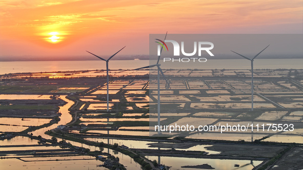 A wind farm is being seen at sunset in Wuxi, China, on April 24, 2024. 