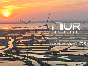 A wind farm is being seen at sunset in Wuxi, China, on April 24, 2024. (