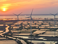 A wind farm is being seen at sunset in Wuxi, China, on April 24, 2024. (