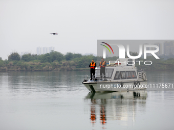 Fishing officials are driving a boat and using a drone to conduct a no-fishing inspection in the Shunqing section of the Jialing River in Na...