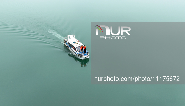 Fishing officials are driving a boat and using a drone to conduct a no-fishing inspection in the Shunqing section of the Jialing River in Na...