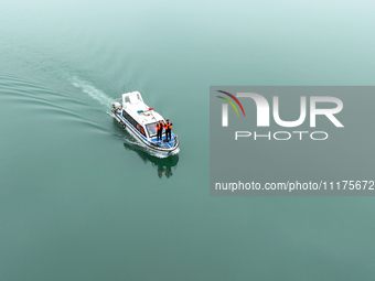 Fishing officials are driving a boat and using a drone to conduct a no-fishing inspection in the Shunqing section of the Jialing River in Na...