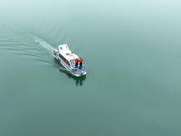 Fishing officials are driving a boat and using a drone to conduct a no-fishing inspection in the Shunqing section of the Jialing River in Na...