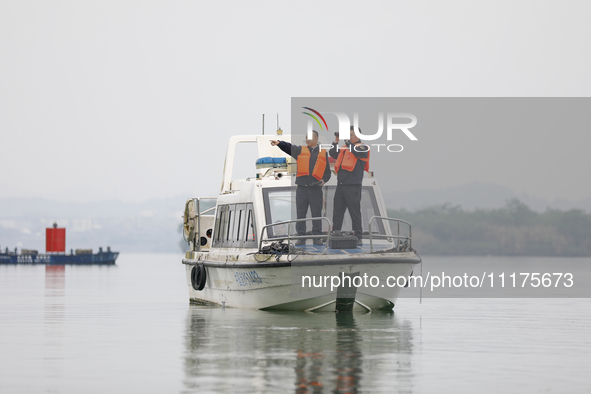 Fishing officials are driving a boat and using a drone to conduct a no-fishing inspection in the Shunqing section of the Jialing River in Na...