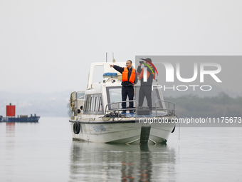 Fishing officials are driving a boat and using a drone to conduct a no-fishing inspection in the Shunqing section of the Jialing River in Na...