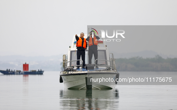 Fishing officials are driving a boat and using a drone to conduct a no-fishing inspection in the Shunqing section of the Jialing River in Na...