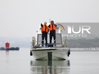 Fishing officials are driving a boat and using a drone to conduct a no-fishing inspection in the Shunqing section of the Jialing River in Na...