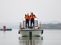 Fishing officials are driving a boat and using a drone to conduct a no-fishing inspection in the Shunqing section of the Jialing River in Na...