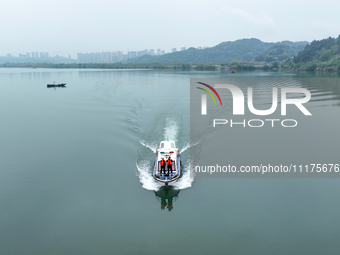 Fishing officials are driving a boat and using a drone to conduct a no-fishing inspection in the Shunqing section of the Jialing River in Na...