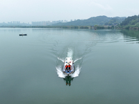 Fishing officials are driving a boat and using a drone to conduct a no-fishing inspection in the Shunqing section of the Jialing River in Na...