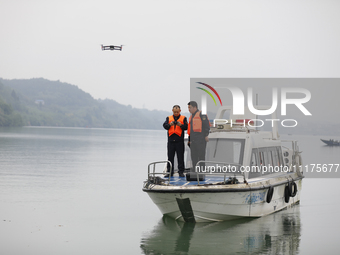 Fishing officials are driving a boat and using a drone to conduct a no-fishing inspection in the Shunqing section of the Jialing River in Na...