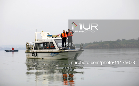 Fishing officials are driving a boat and using a drone to conduct a no-fishing inspection in the Shunqing section of the Jialing River in Na...