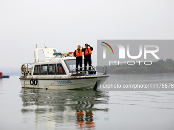 Fishing officials are driving a boat and using a drone to conduct a no-fishing inspection in the Shunqing section of the Jialing River in Na...