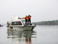 Fishing officials are driving a boat and using a drone to conduct a no-fishing inspection in the Shunqing section of the Jialing River in Na...