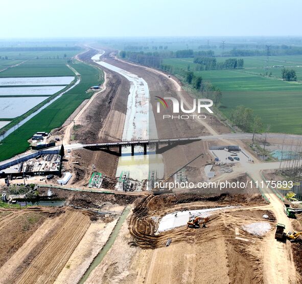 Workers are reinforcing beaches and embankments in Suqian, Jiangsu Province, China, on April 25, 2024. 