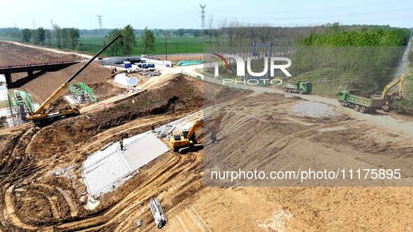 Workers are reinforcing beaches and embankments in Suqian, Jiangsu Province, China, on April 25, 2024. 