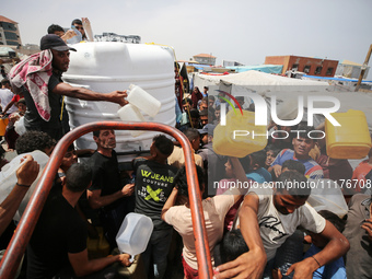 Displaced Palestinians are lining up to fill their containers with water in Deir Balah in the central Gaza Strip on April 25, 2024, amid ong...