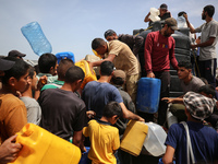 Displaced Palestinians are lining up to fill their containers with water in Deir Balah in the central Gaza Strip on April 25, 2024, amid ong...