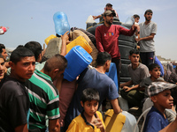 Displaced Palestinians are lining up to fill their containers with water in Deir Balah in the central Gaza Strip on April 25, 2024, amid ong...