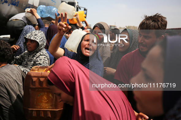 Displaced Palestinians are lining up to fill their containers with water in Deir Balah in the central Gaza Strip on April 25, 2024, amid ong...