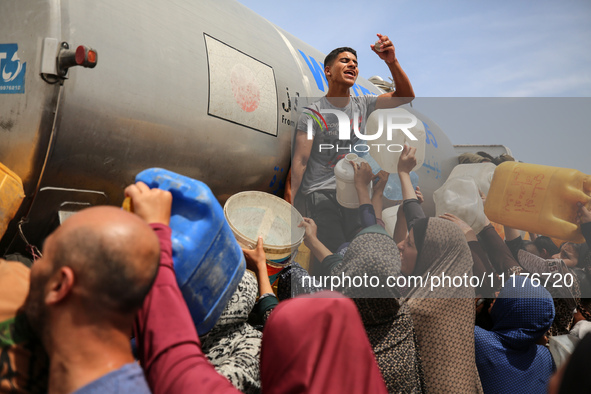 Displaced Palestinians are lining up to fill their containers with water in Deir Balah in the central Gaza Strip on April 25, 2024, amid ong...