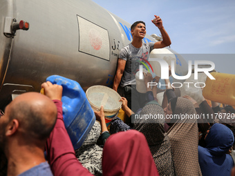 Displaced Palestinians are lining up to fill their containers with water in Deir Balah in the central Gaza Strip on April 25, 2024, amid ong...