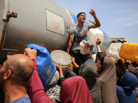 Displaced Palestinians are lining up to fill their containers with water in Deir Balah in the central Gaza Strip on April 25, 2024, amid ong...