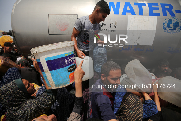 Displaced Palestinians are lining up to fill their containers with water in Deir Balah in the central Gaza Strip on April 25, 2024, amid ong...