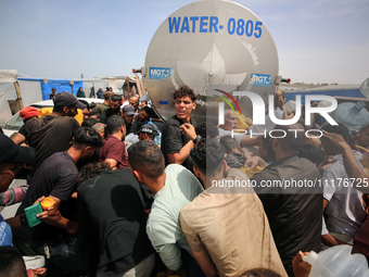 Displaced Palestinians are lining up to fill their containers with water in Deir Balah in the central Gaza Strip on April 25, 2024, amid ong...