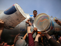 Displaced Palestinians are lining up to fill their containers with water in Deir Balah in the central Gaza Strip on April 25, 2024, amid ong...