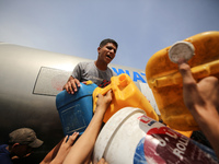 Displaced Palestinians are lining up to fill their containers with water in Deir Balah in the central Gaza Strip on April 25, 2024, amid ong...