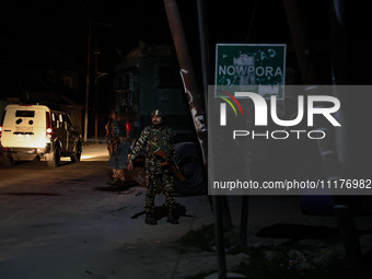 Security forces are standing near the encounter site where a confrontation between militants and Indian forces began in Nowpora Sopore, Jamm...