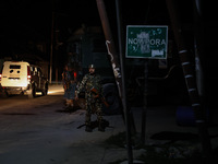 Security forces are standing near the encounter site where a confrontation between militants and Indian forces began in Nowpora Sopore, Jamm...