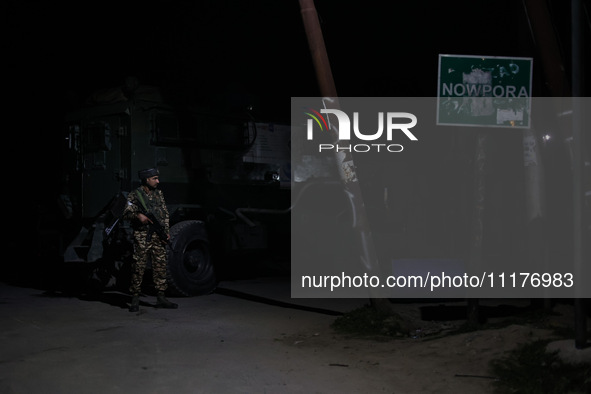 Security forces are standing near the encounter site where a confrontation between militants and Indian forces began in Nowpora Sopore, Jamm...