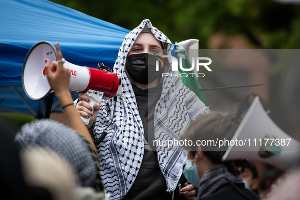 A demonstrator lead chants at an encampment for Palestine at George Washington University (GWU), Washington, DC, April 25, 2024.  Students e...