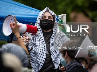 A demonstrator lead chants at an encampment for Palestine at George Washington University (GWU), Washington, DC, April 25, 2024.  Students e...