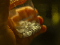 A plastic bottle with white coloured antidepressant pills hel in a man's hand is seen in this illustration photo in Warsaw, Poland on 25 Apr...